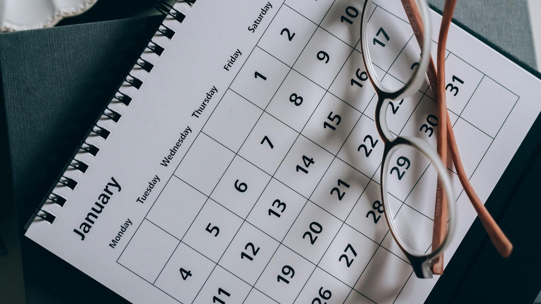 brown framed eyeglasses on a calendar